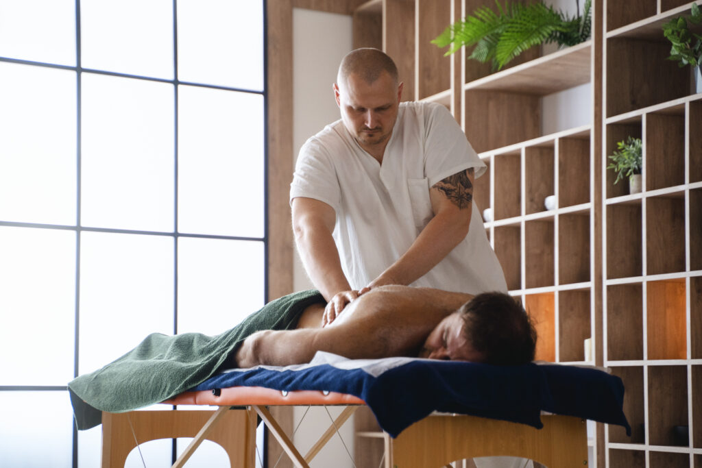 side-view-man-getting-professional-massage-2 - Hope Wellness